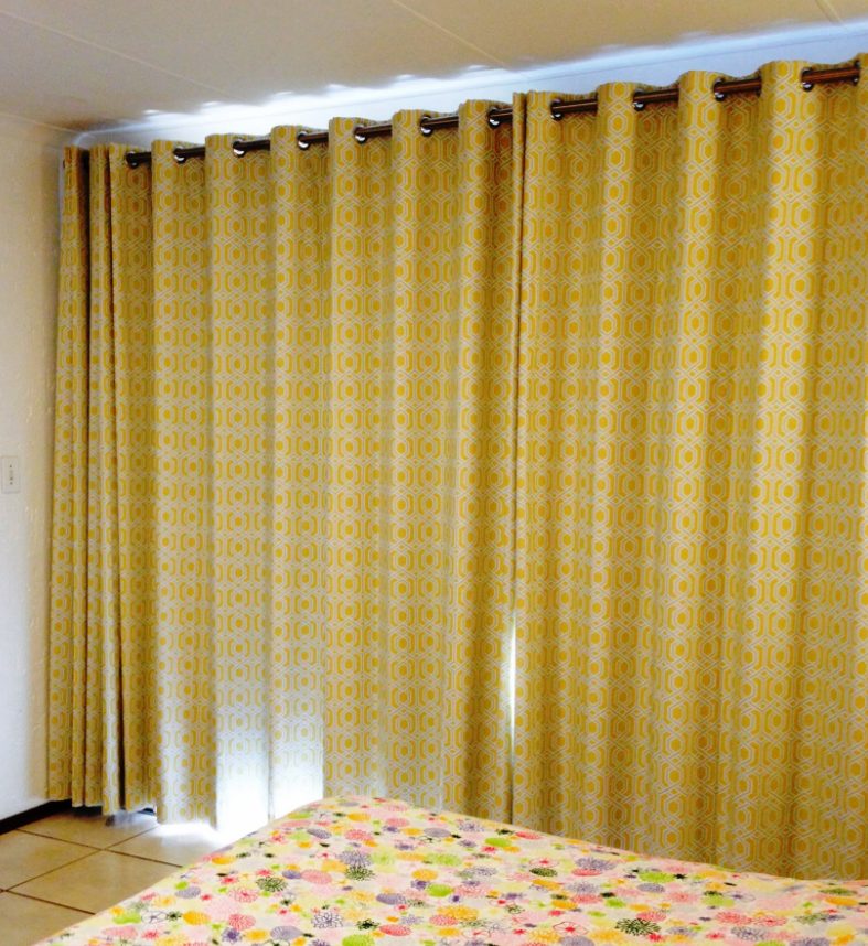 Made-to-measure mustard patterned curtains